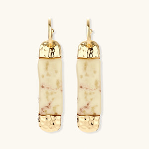 Cylindrical bar earrings featuring speckled natural resin center with polished metal caps and lever-back closures
